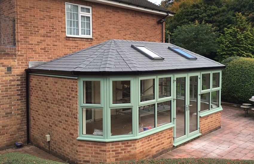 Tiled roof in Pewter Grey with roof windows and Chartwell Green frames