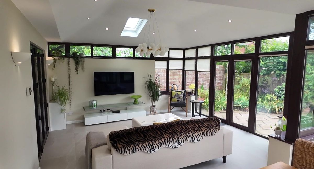 Bright, light lounge under a tiled roof with skylights