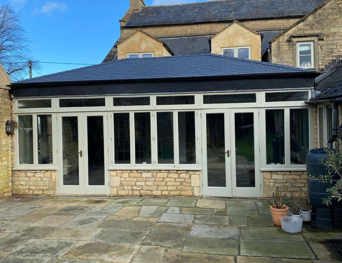 After: lean-to glass roof replaced with a tiled roof in Stone Black
