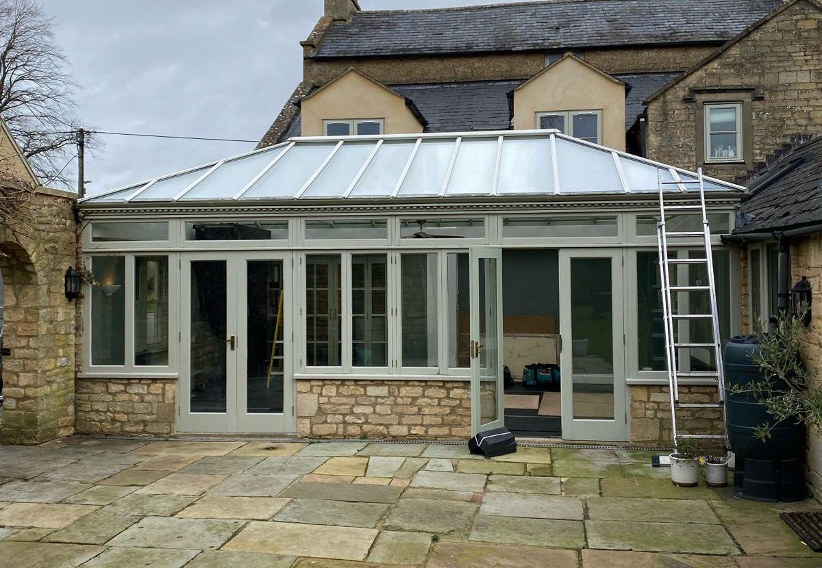 Before: lean-to glass roof replaced with a tiled roof in Stone Black
