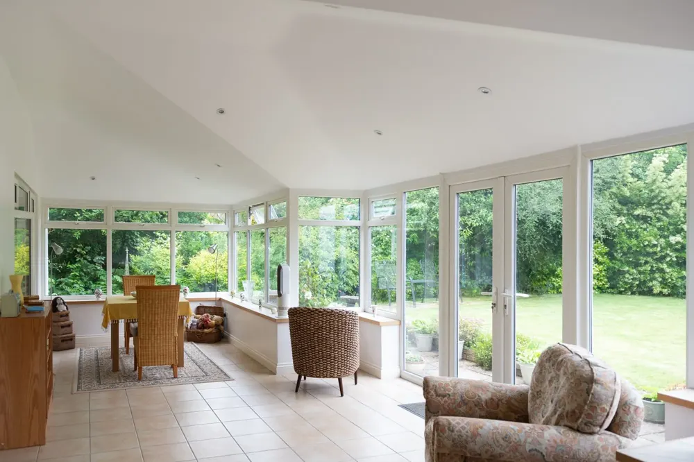 Conservatory interior with a plastered ceiling under a new tiled roof